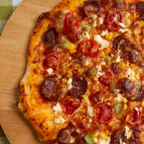 Friends eating pizza celebrating national sausage pizza day