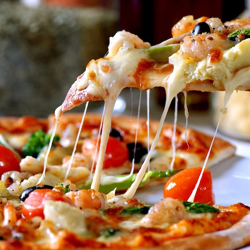 Friends eating pizza celebrating national sausage pizza day
