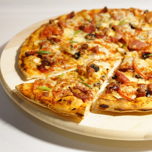 Friends eating pizza celebrating national sausage pizza day