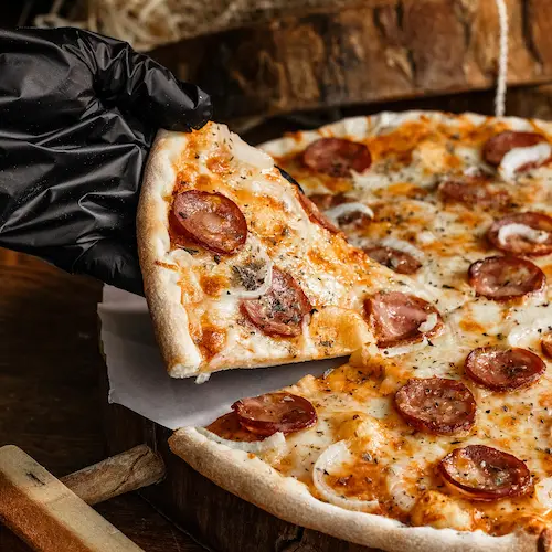 Freshly baked thin Sausage Pizza with melted cheddar cheese.