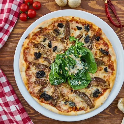Spicy Sausage Pizza with spinach and parmesan cheese.