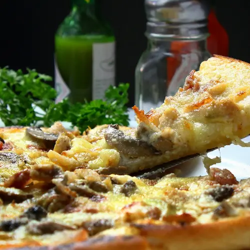 Sliced Sausage Pizza with Mushroom with Basil toppings